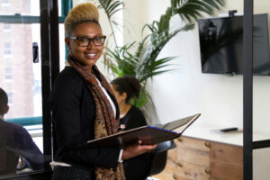 Business woman smiling at conference room door